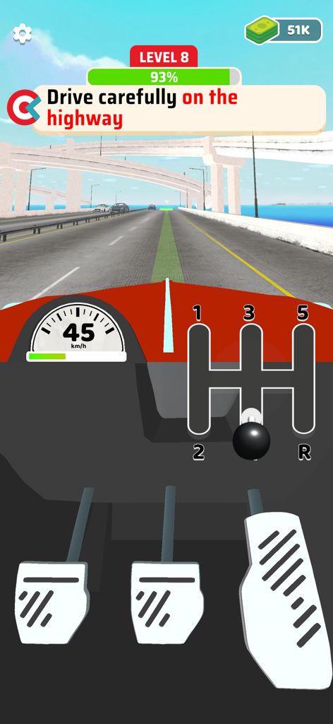 First person view of a manual car driving simulator with stick shift and pedals on a highway