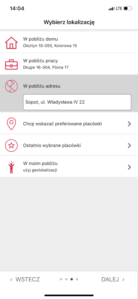 SALTUS Zdrowie app screen for choosing a medical facility location with options for home, work, specific address, and geolocation.