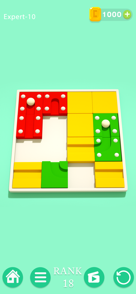 A sliding block puzzle level in Puzzledom where players align red yellow and green blocks to guide a white ball