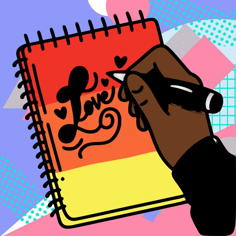 a hand writing “love” in calligraphy on a notebook