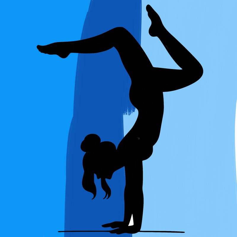 a woman doing a handstand