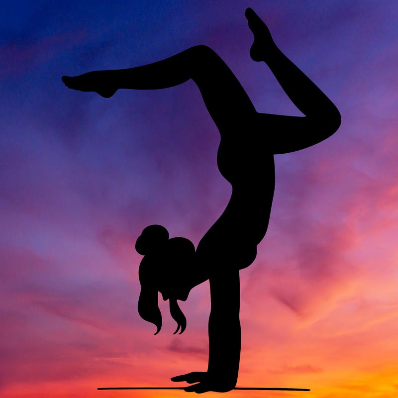 a woman doing a handstand
