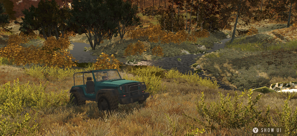 Teal off-road vehicle driving through a grassy field in the European wilderness