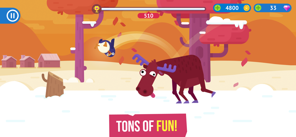 A penguin flying over a moose in a colorful snowy landscape from Bouncemasters arcade game.