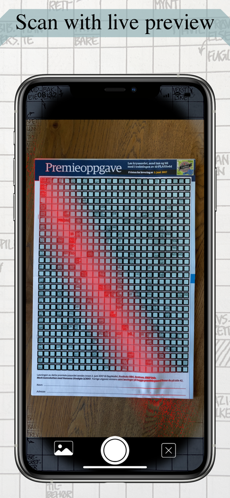 A smartphone using a live camera preview to scan a physical crossword puzzle from a newspaper.