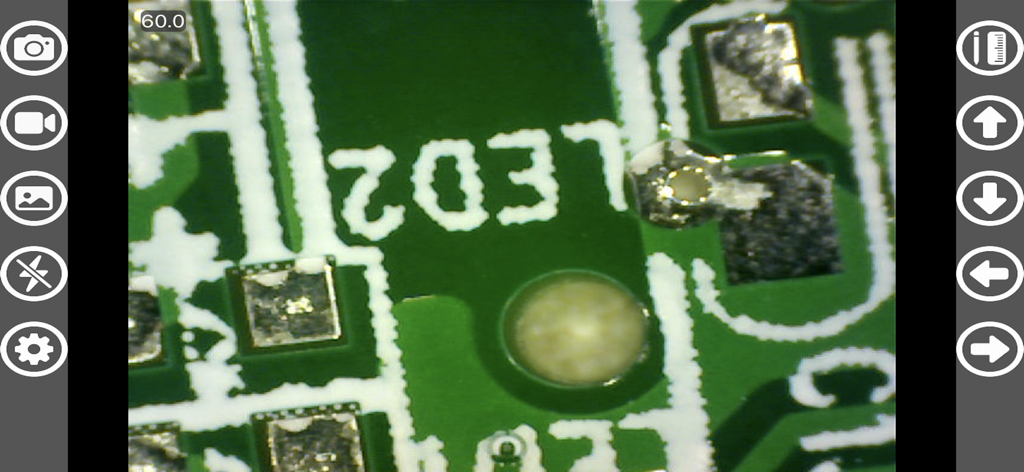 Close-up microscopic view of a green circuit board using the Hiview Plus app interface with measurement and capture tools.