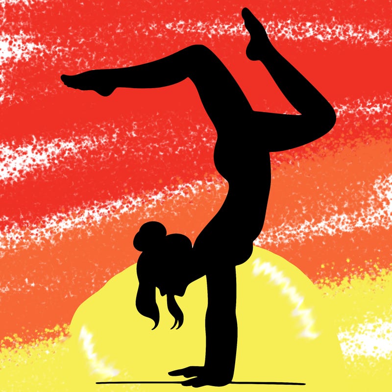a woman doing a handstand