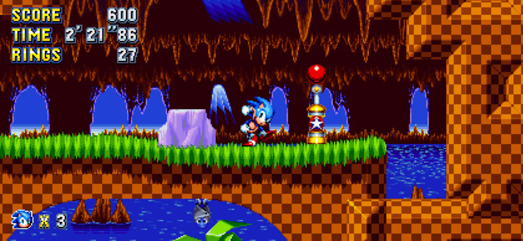 Sonic Mania Plus - NETFLIX - Screenshot di gioco di Sonic the Hedgehog in un livello retrò 2D pixel art vicino a un checkpoint