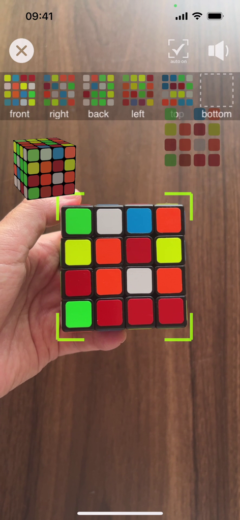 App interface showing AR scanning of a physical 4x4 puzzle cube