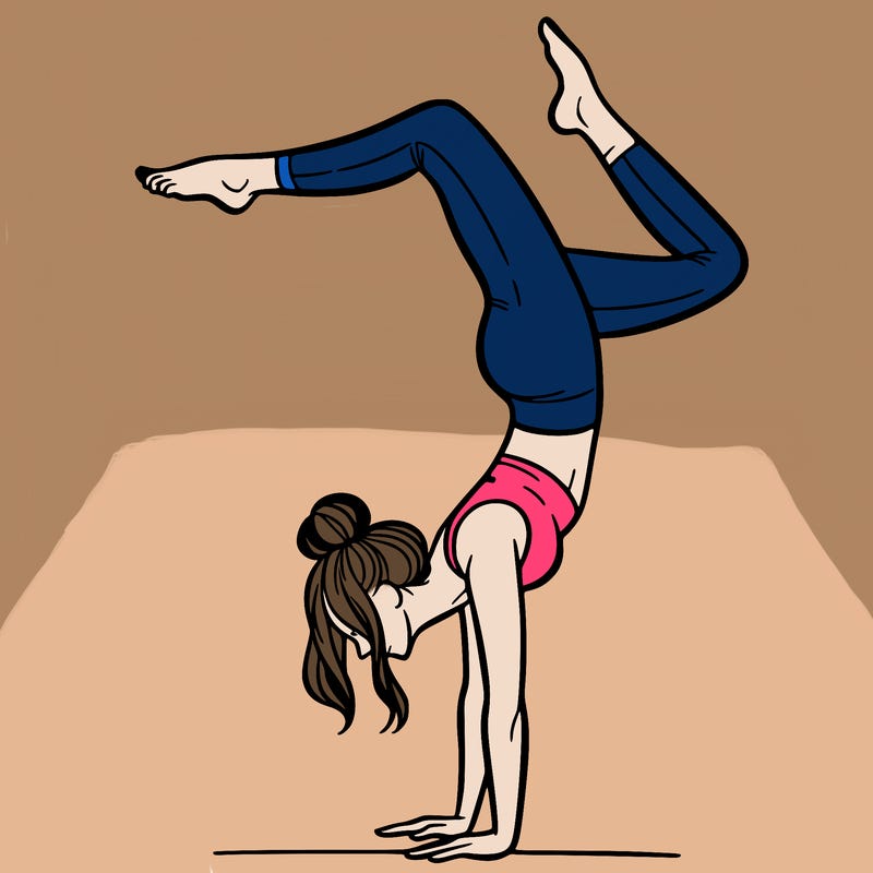 a woman doing a handstand