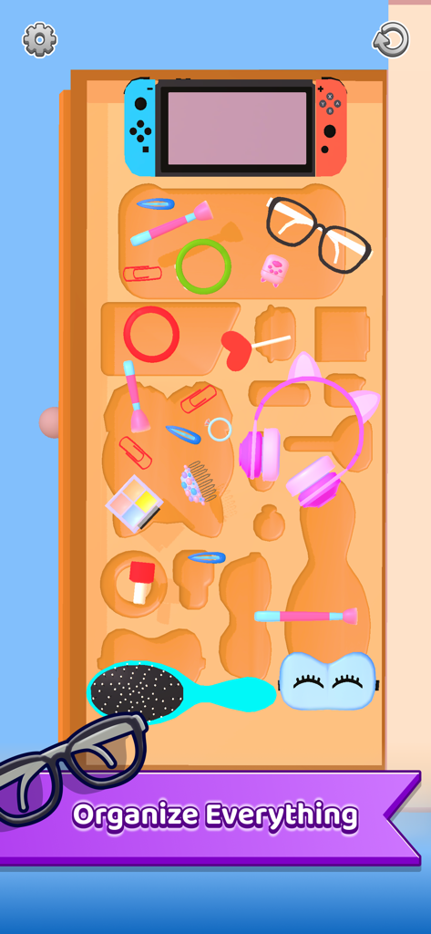 Um nível de jogo para celular mostrando vários itens de estilo de vida como fones de ouvido e óculos sendo organizados em uma bandeja organizadora de madeira