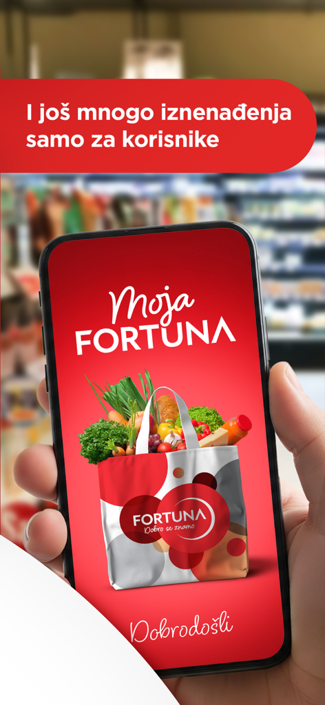 Moja Fortuna - Hand holding a smartphone displaying the Moja Fortuna grocery loyalty app welcome screen with a shopping bag of fresh produce