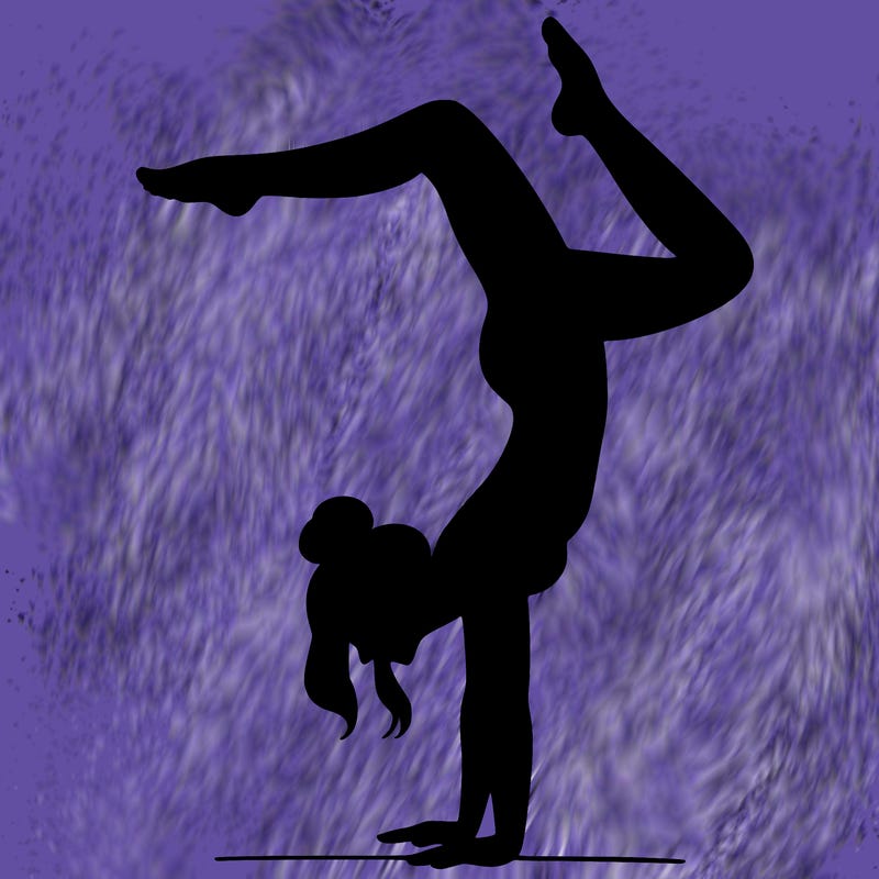 a woman doing a handstand