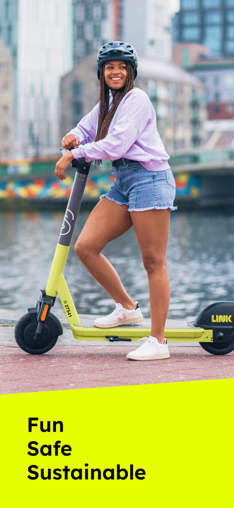 Smiling woman wearing a helmet on a lime green Superpedestrian LINK electric scooter
