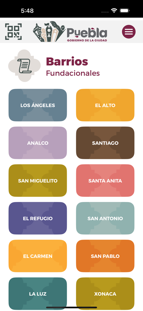 La Ciudad Como Museo - A mobile screen showing a list of foundational neighborhoods in Puebla with colorful labeled buttons for navigation.