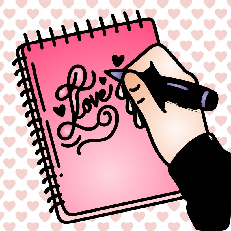 a hand writing “love” in calligraphy on a notebook