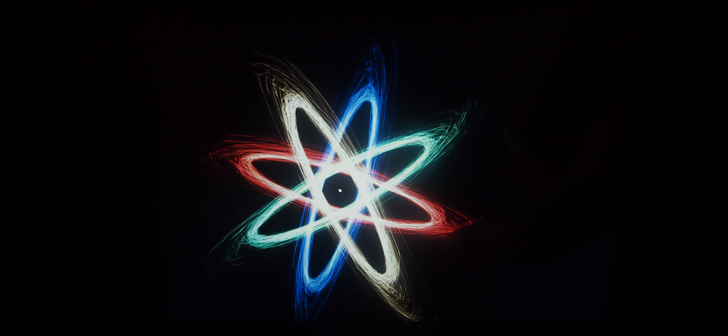 Particelle luminose al neon colorate che formano uno schema atomico simmetrico su sfondo nero