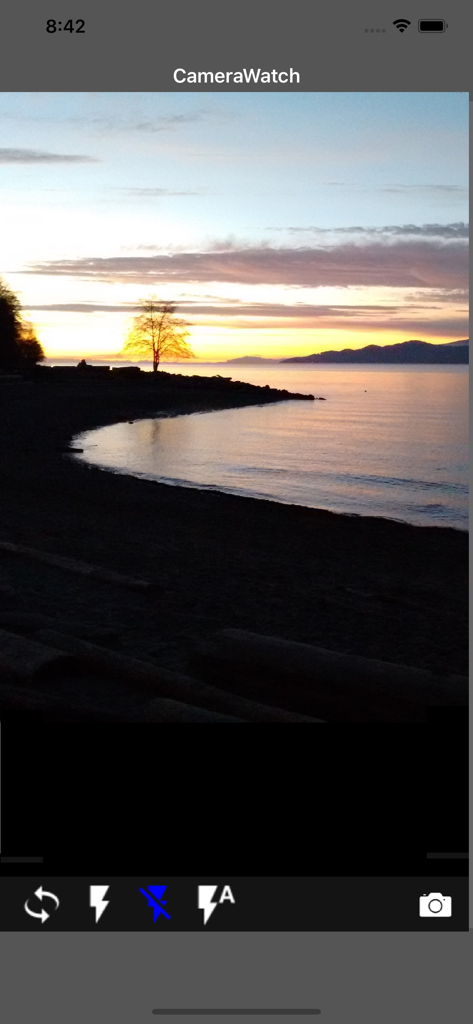 Camera Remote Watch - iPhone camera viewfinder showing a beach sunset with control buttons