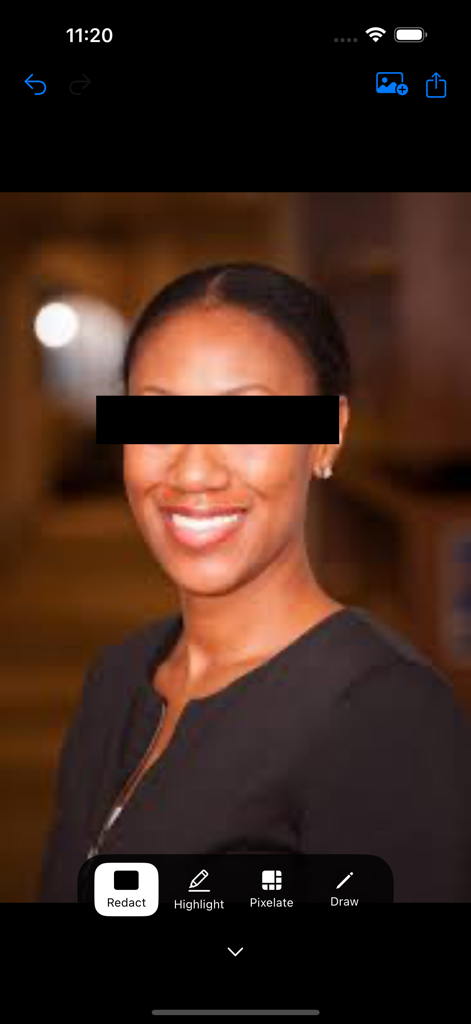 A portrait photo with a black redaction box covering the eyes using the Redact app mobile interface