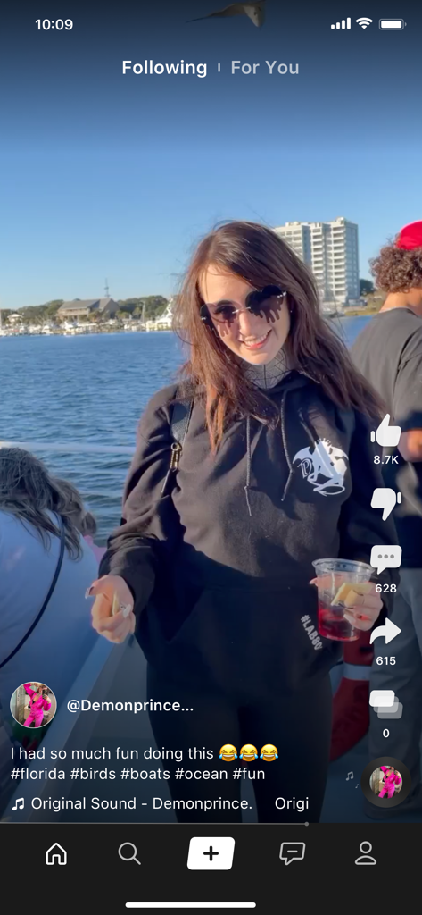 A woman sharing an authentic short video on the Clapper app from a boat