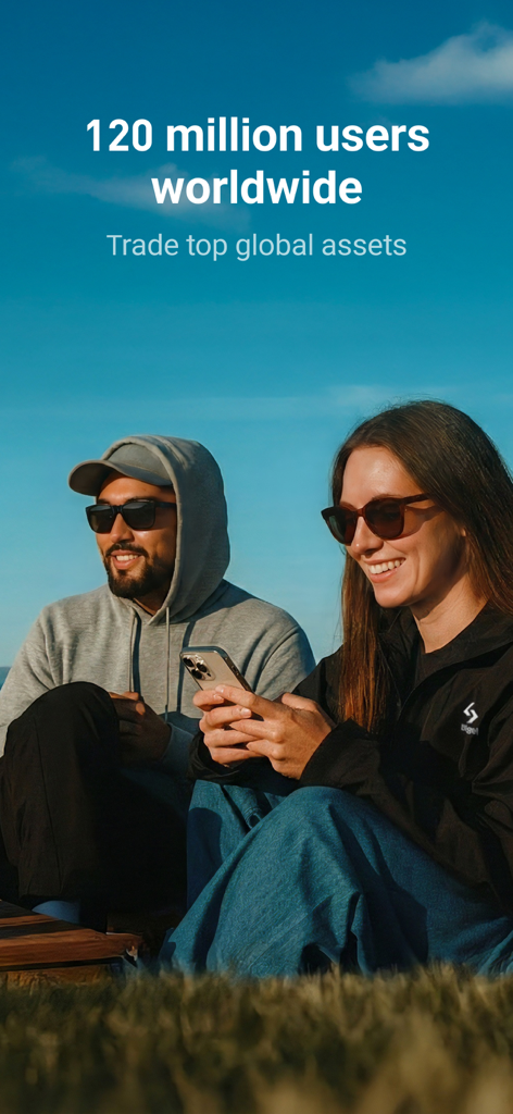 A man and woman outdoors smiling while using the Bitget app for global asset trading.
