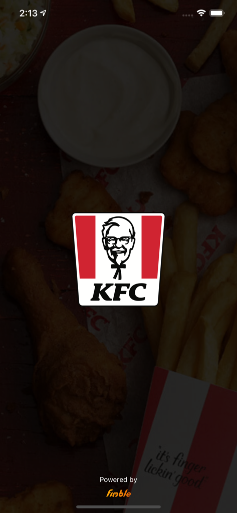 KFC Greece - Pantalla de inicio de la app KFC Grecia con el icónico logo sobre un fondo de pollo frito y papas fritas