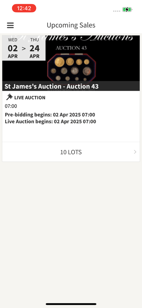 Upcoming live coin auction details on the STJ Auctions mobile app showing auction dates and lot information.
