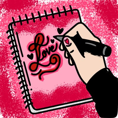 a hand writing “love” in calligraphy on a notebook