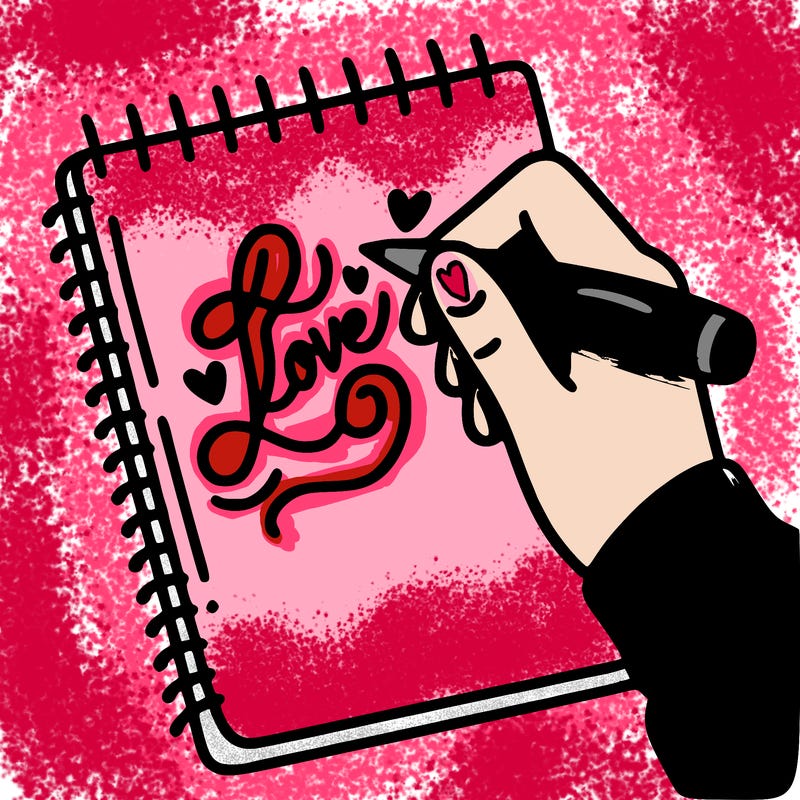 a hand writing “love” in calligraphy on a notebook