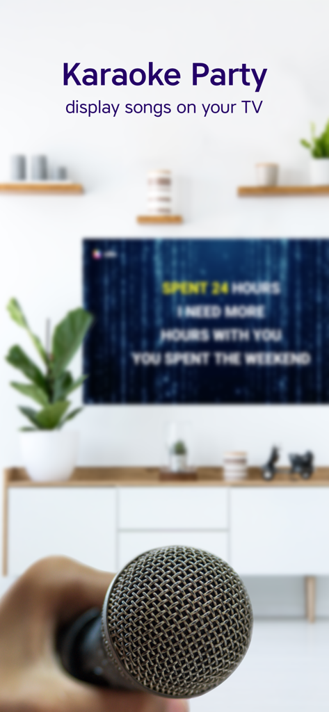 A hand holding a microphone in front of a TV displaying karaoke lyrics using the Yokee app