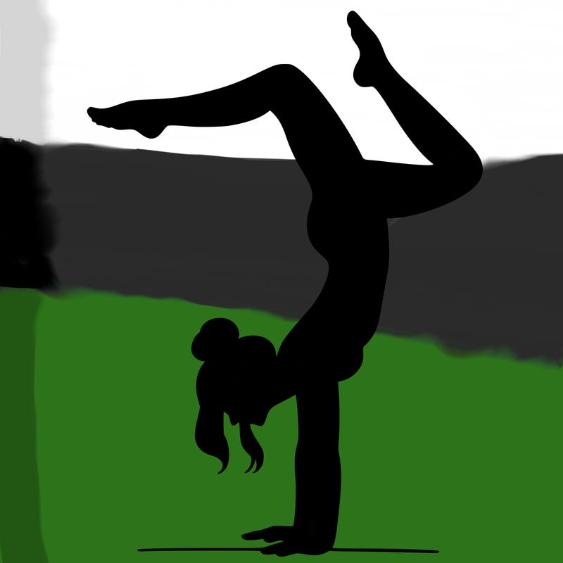 a woman doing a handstand