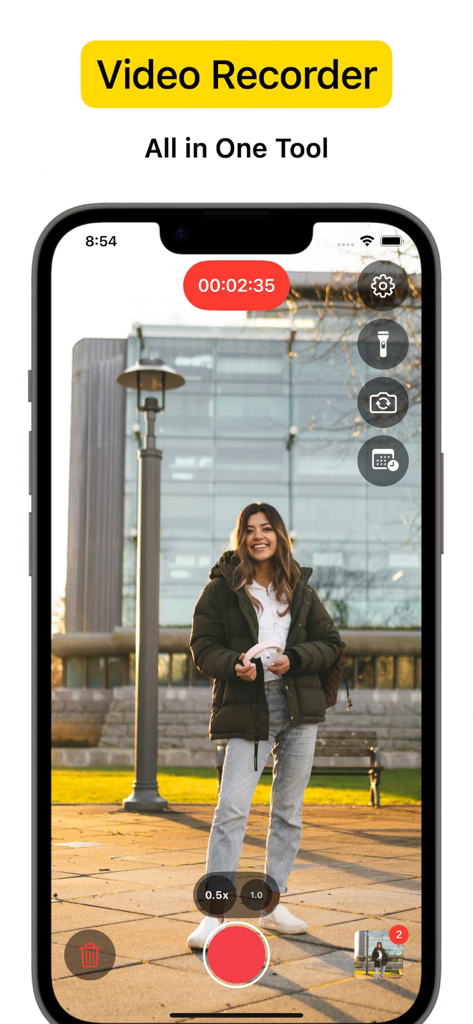 VideoCam app interface recording a woman standing in a park with camera tools