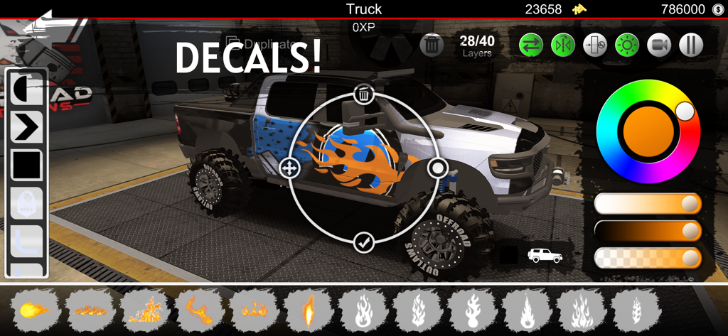 Uma caminhonete sendo customizada com decalques de chamas e uma roda de cores na garagem do Offroad Outlaws