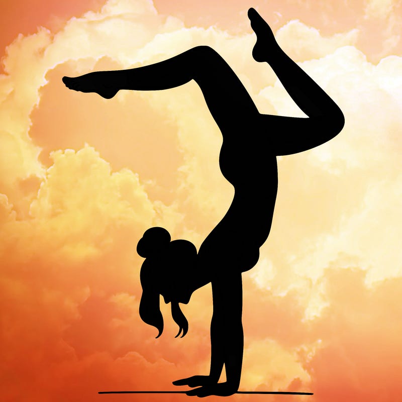 a woman doing a handstand