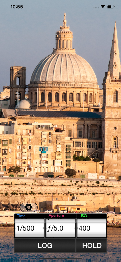 Pocket Light Meter - Pocket Light Meter app interface showing exposure settings for shutter speed aperture and ISO over a scenic background