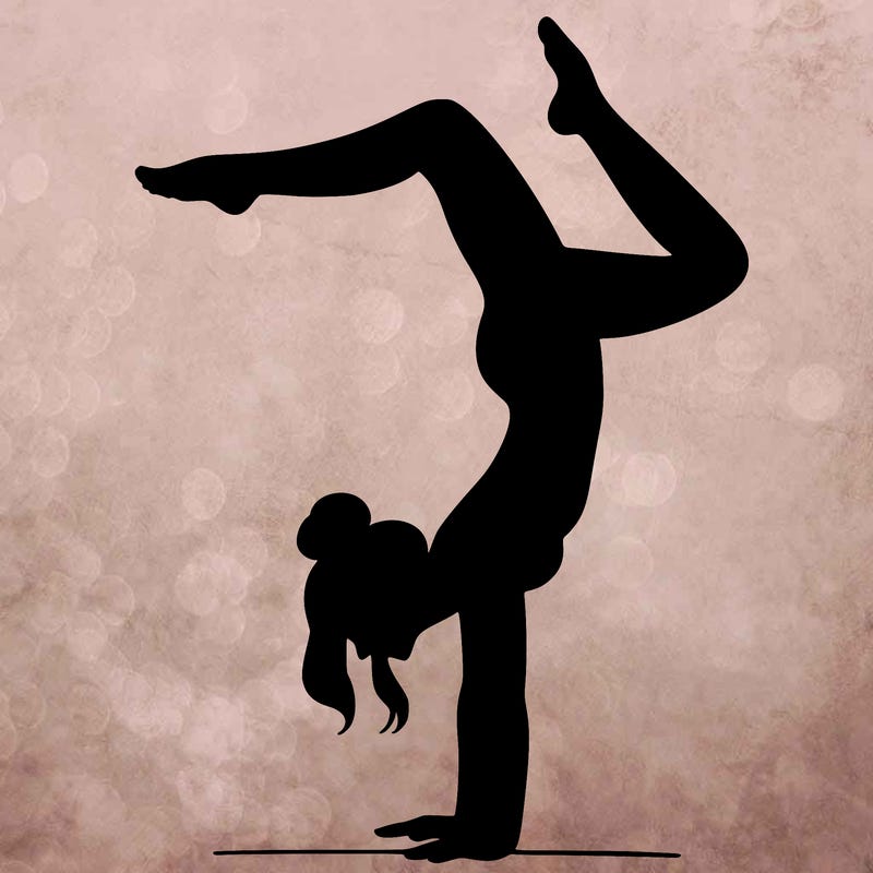 a woman doing a handstand