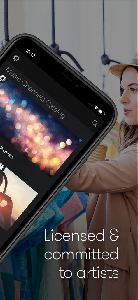 Smartphone displaying the Stingray Music for Business app in a retail boutique setting with text about licensed music.