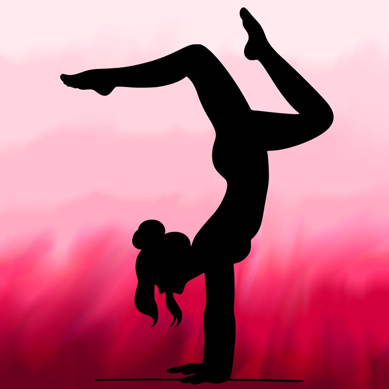 a woman doing a handstand