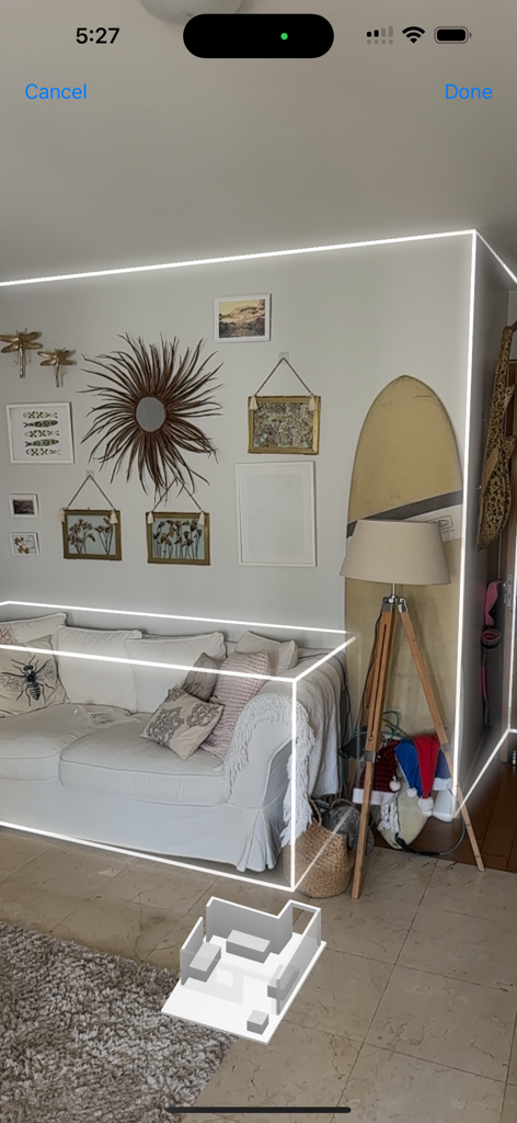 LiDAR scanning interface showing white wireframe outlines of a sofa and walls in a living room