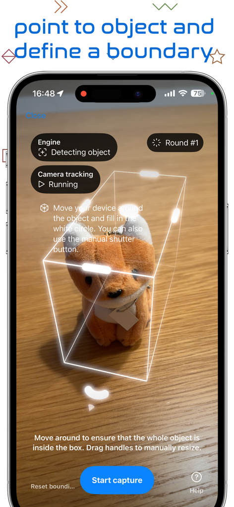 3Dオブジェクトキャプチャアプリのインターフェースに、スキャン用にぬいぐるみを取り囲むAR境界ボックスが表示されています