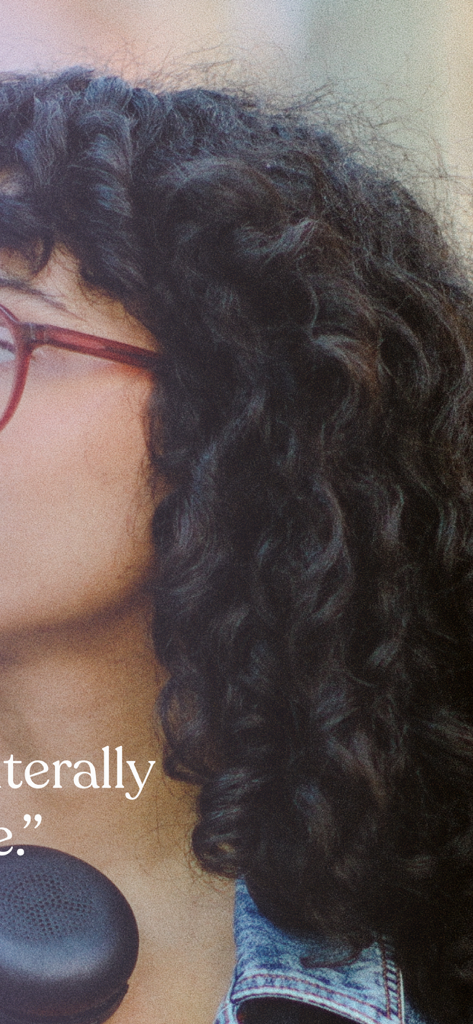 A young woman with curly hair and glasses representing a Tiimo app user
