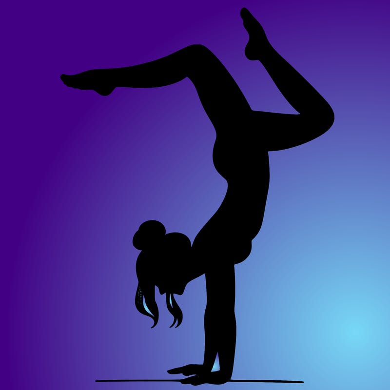 a woman doing a handstand