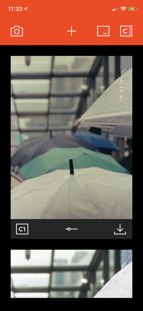 Interface of Filmlike Camera app displaying a photo of colorful umbrellas with a vintage film filter and date stamp