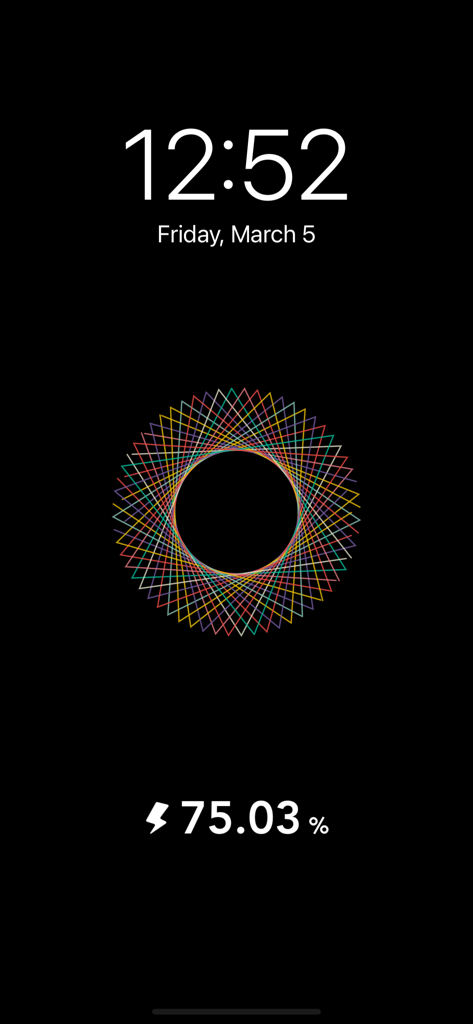 iCharging - play screensaver - A colorful geometric mandala animation on a black iPhone charging screensaver with battery percentage and digital clock