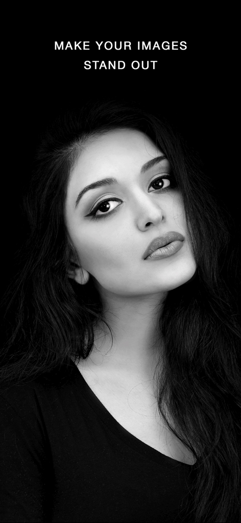 High contrast black and white portrait of a woman against a dark background