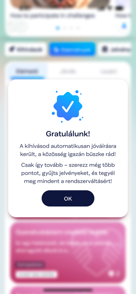 A congratulations popup in the TISZA Vilag app with a blue checkmark and success message for completing a challenge