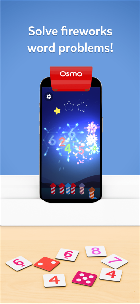 OsmoベースのiPhoneが、テーブルに物理的な数字タイルを置いた算数花火ゲームを表示している画像