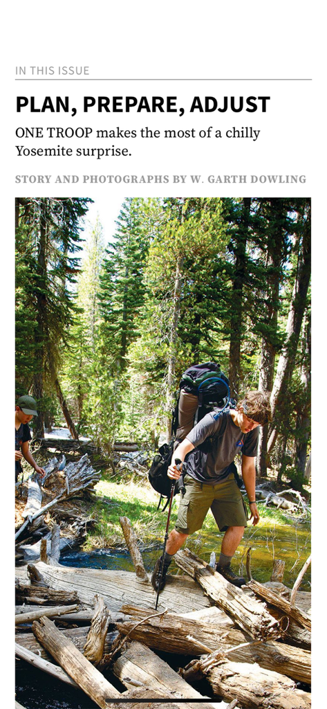 Scout Life Magazine - A scout with a large backpack hiking across logs in a forest