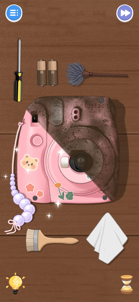 A dirty pink camera being cleaned with a brush and cloth in the Housify ASMR mobile game.