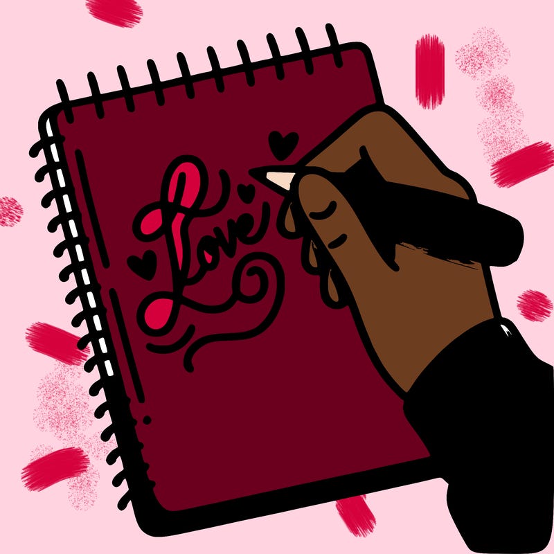 a hand writing “love” in calligraphy on a notebook